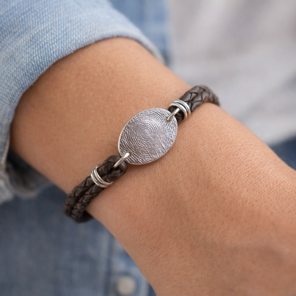 Person wearing fingerprint leather bracelet