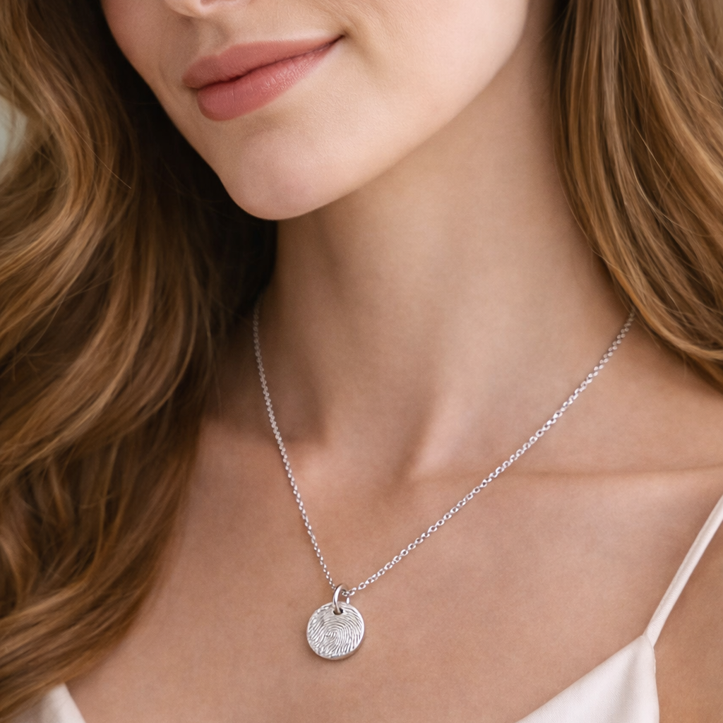 Woman wearing a circular fingerprint charm