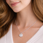 fingerprint on a sterling silver circular pendant on a woman