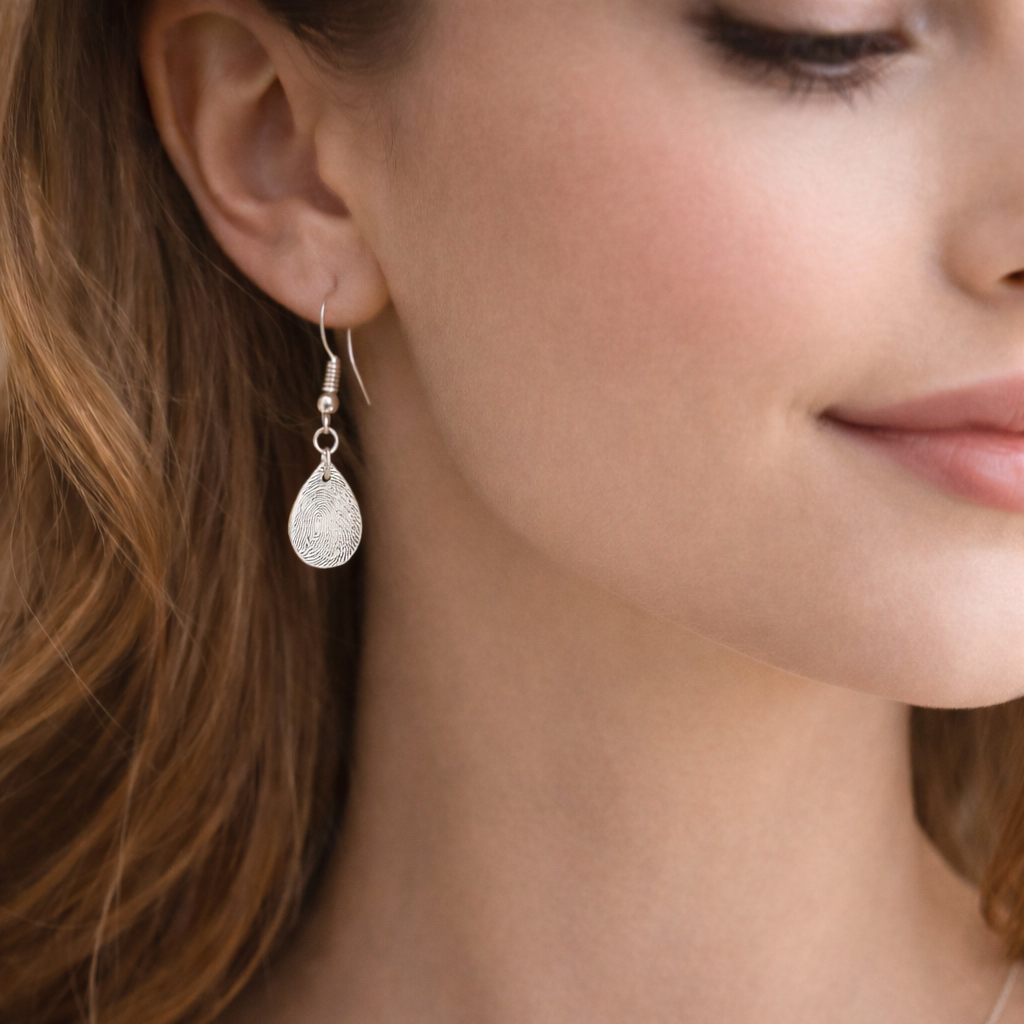 Fingeprint teardrop earrings on a woman