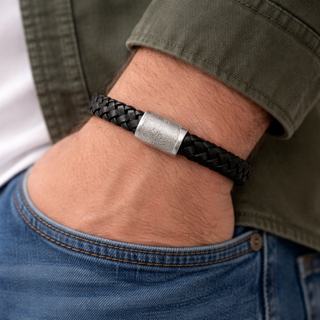 fingerprint charm on a leather bracelet on man's wrist