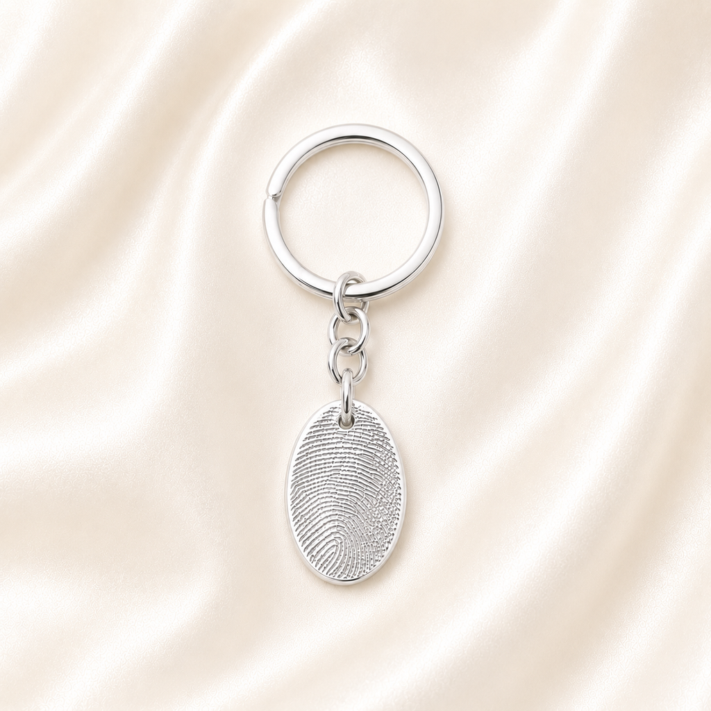 Oval silver charm keyring with personalised fingerprint on it