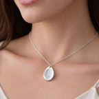 fingerprint on a silver teardrop necklace