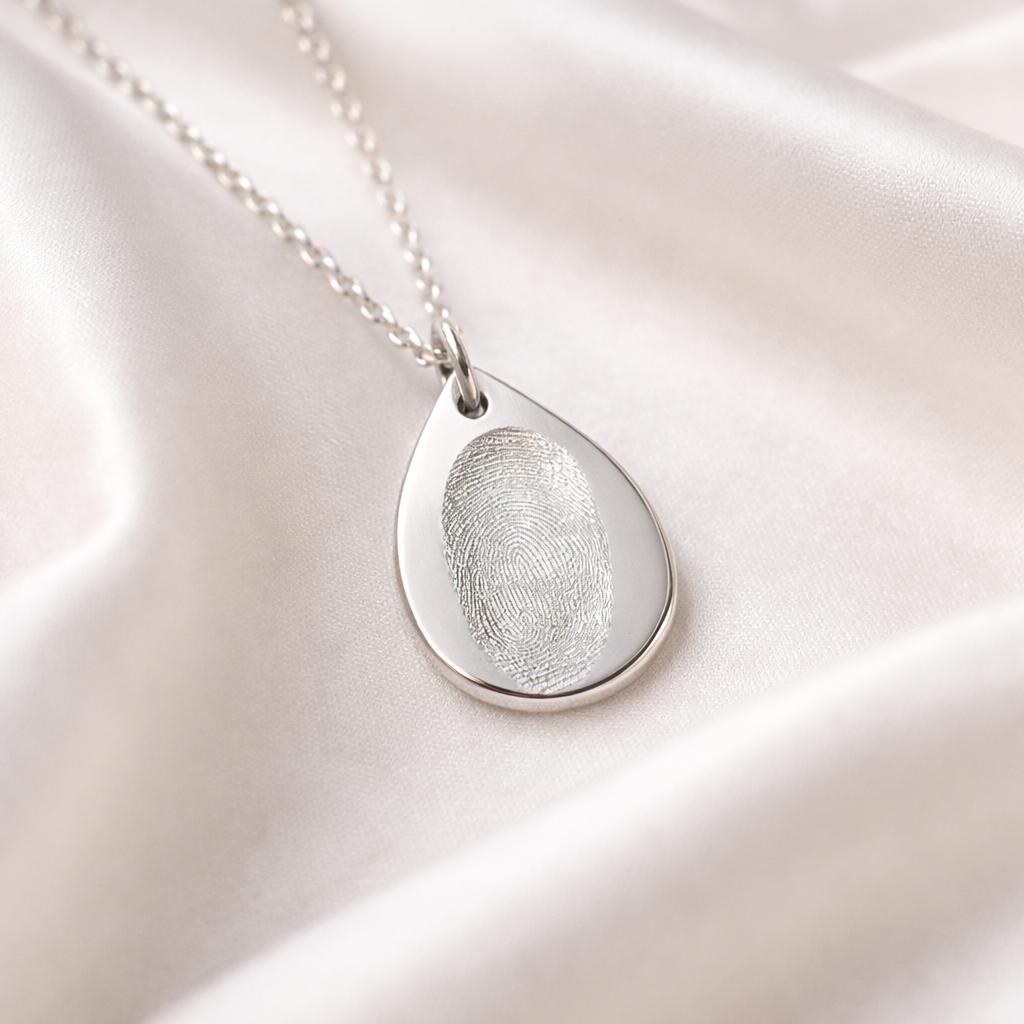 Fingerprint on a silver teardrop necklace