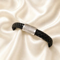 Fingerprint on a thick black leather braided bracelet