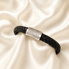 Fingerprint on a thick black leather braided bracelet