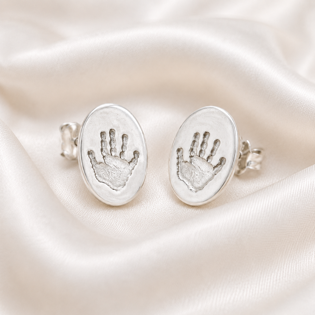 Handprints on silver oval studs