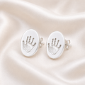 Handprints on oval silver studs