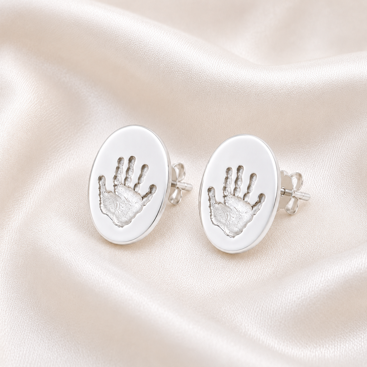 Handprints on oval silver studs