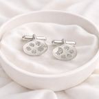 silver cufflinks with pawprints on them