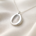 Fingerprint on a silver teardrop pendant