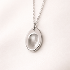 Fingerprint on an oval silver pendant