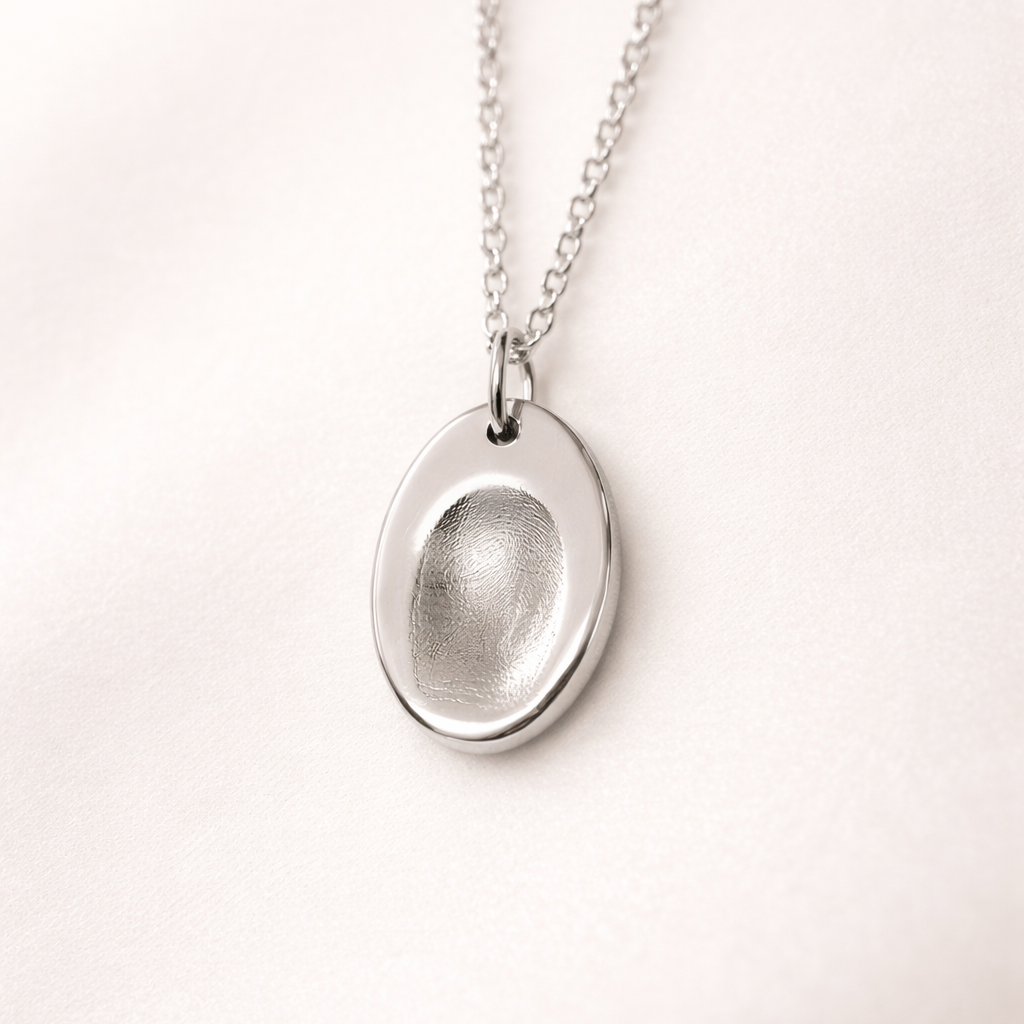 Fingerprint on an oval silver pendant