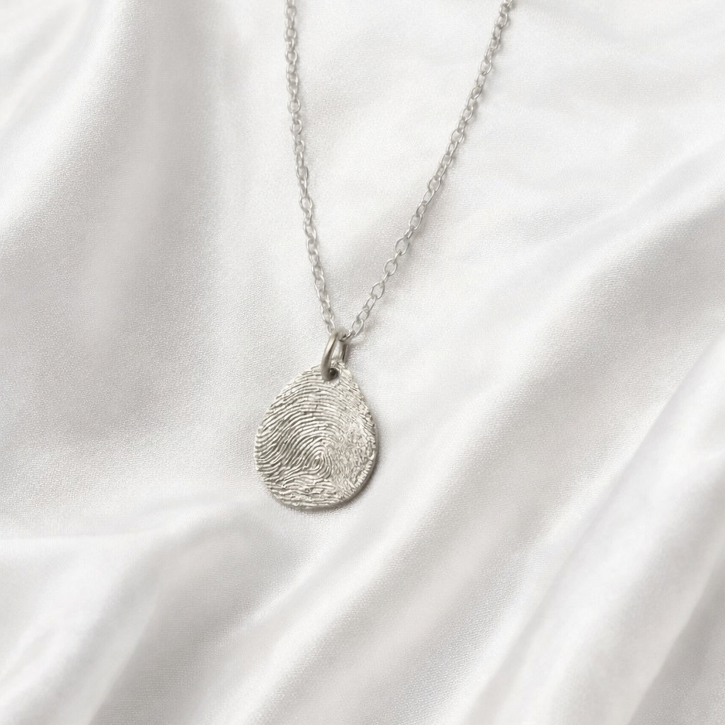 Fingerprint on small teardrop silver pendant