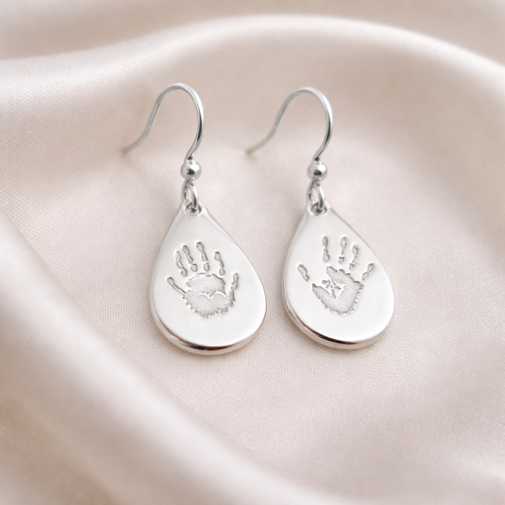Teardrop silver earrings with personalised handprints on each earring