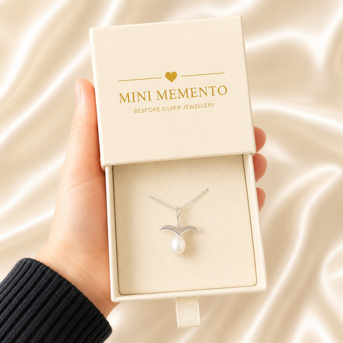 Fresh water pearl with a silver bird necklace