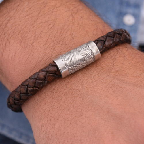 fingerprint charm on leather bracelet worn by man
