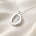 fingerprint on a teardrop shape pendant