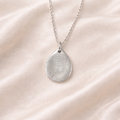 teardrop pendant with fingerprint on it