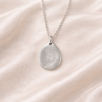 teardrop pendant with fingerprint on it