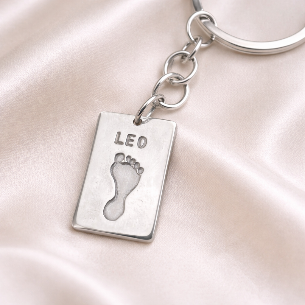 footprint on a silver rectangular keyring