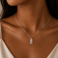 Silver hammer textured rectangular pendant on a woman