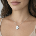 handprint on silver oval necklace