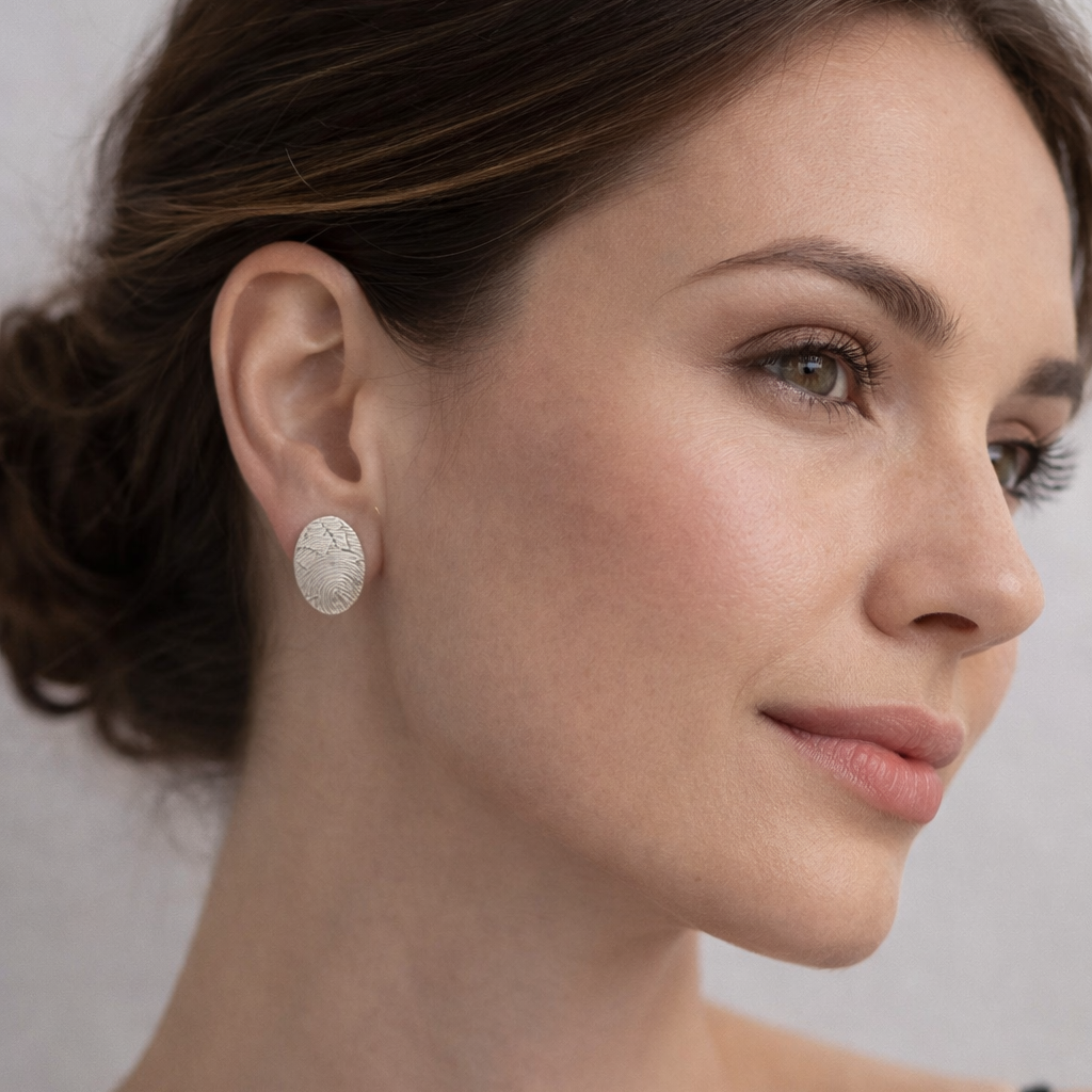 Woman wearing oval fingerprint studs