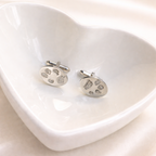 Silver oval cufflinks with personalised pawprints on them.