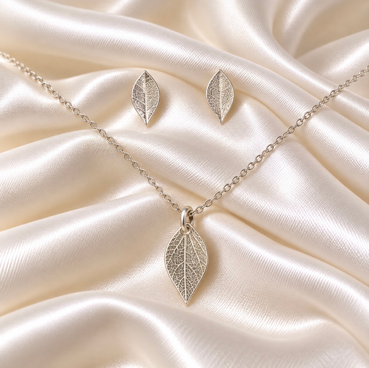 Real leaf imprint on silver stud earrings and pendant 