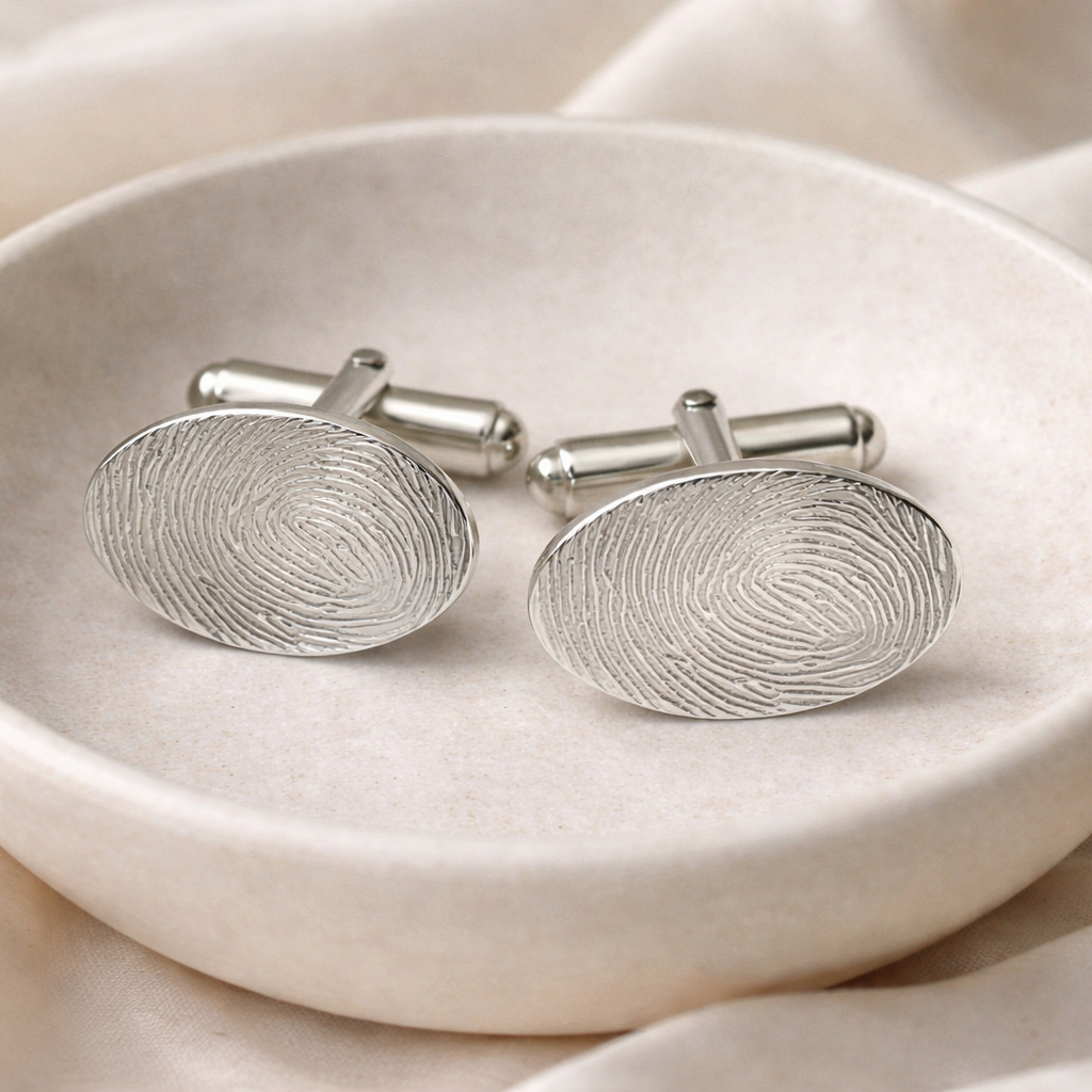 Oval cufflinks with fingerprints on them