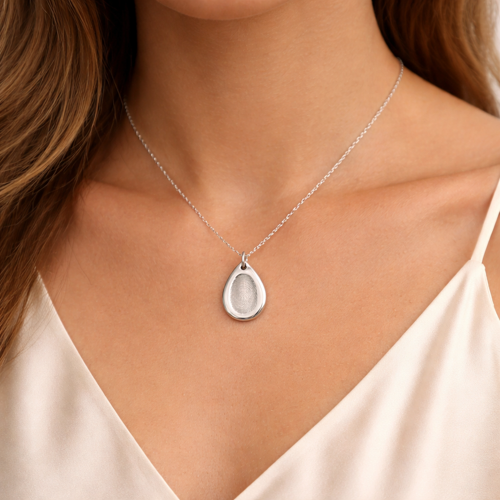 silver fingerprint teardrop necklace on lady