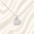 Small silver heart with fingeprint on it