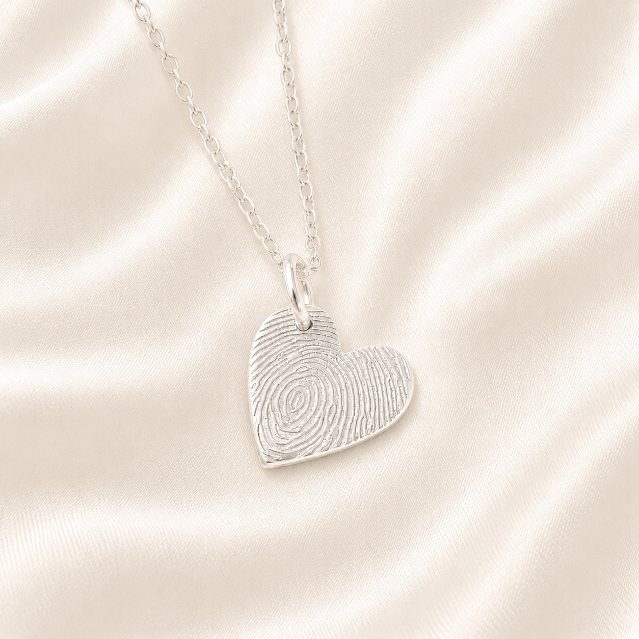 Fingerprint on a small silver heart charm necklace