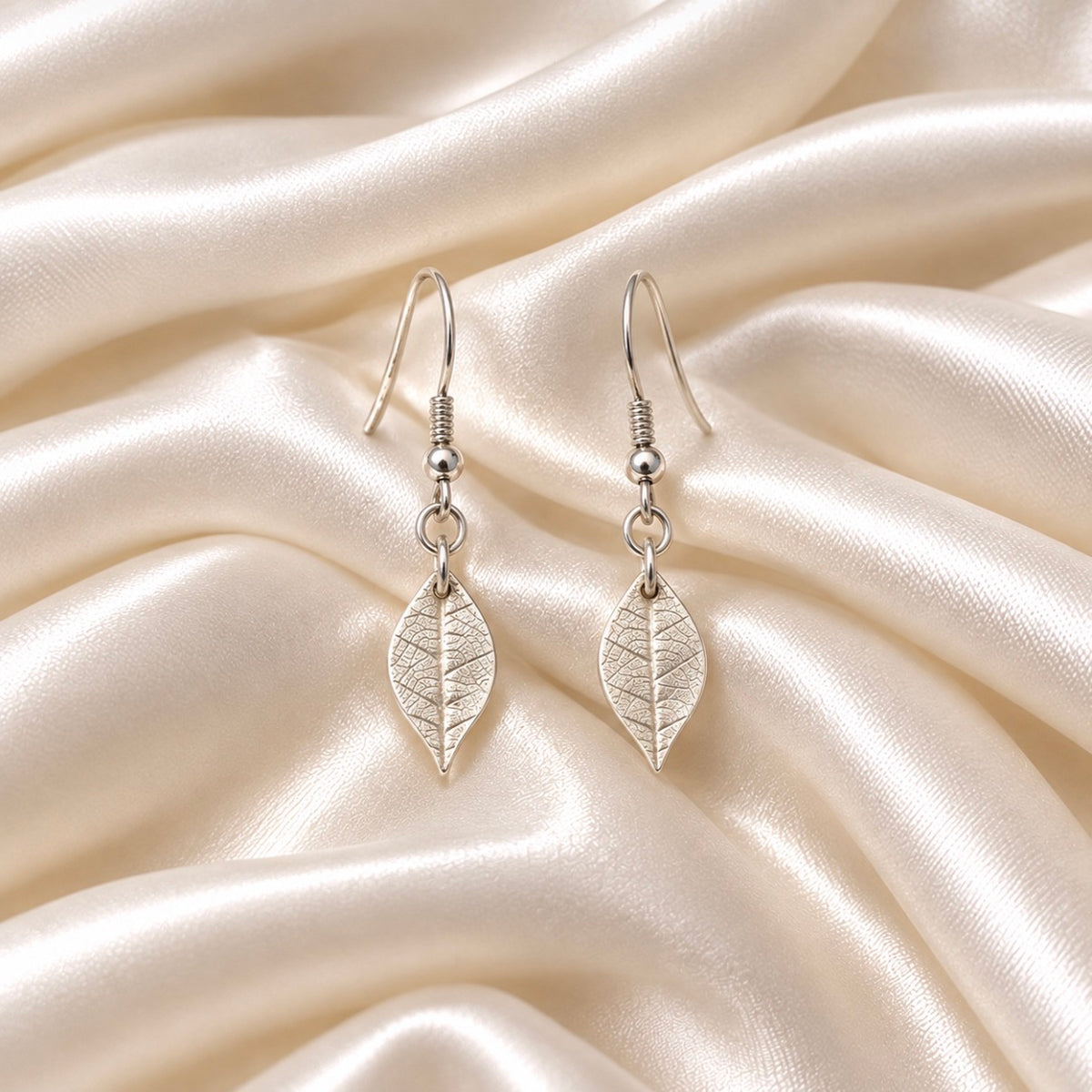 Silver jewellery set of real leaf imprint on a pendant and earrings