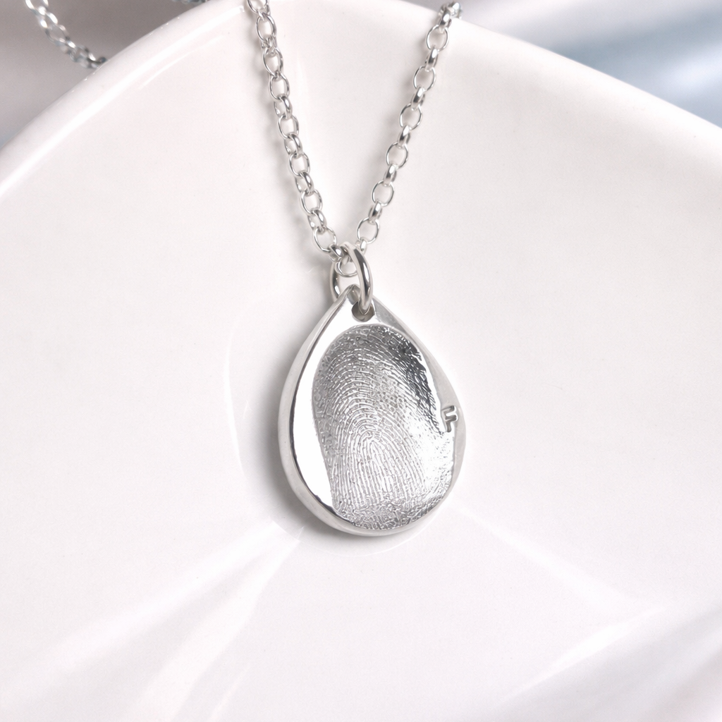fingerprint on a teardrop silver pendant 