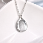 fingerprint on a teardrop silver pendant 
